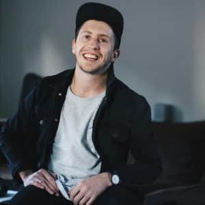 Young man with jean jacket and cap